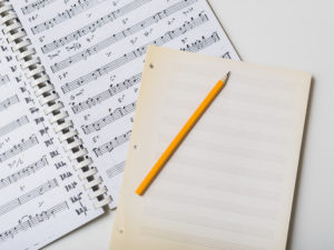 pencil-and-mpty-pages-on-sheet-music